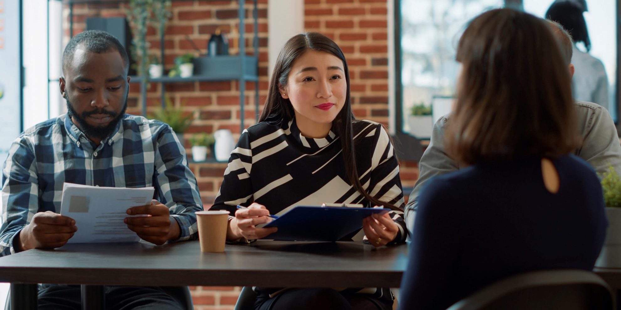 Photo of man and woman conducting job interview illustrates blog: "For How Long is a Background Check Good?"