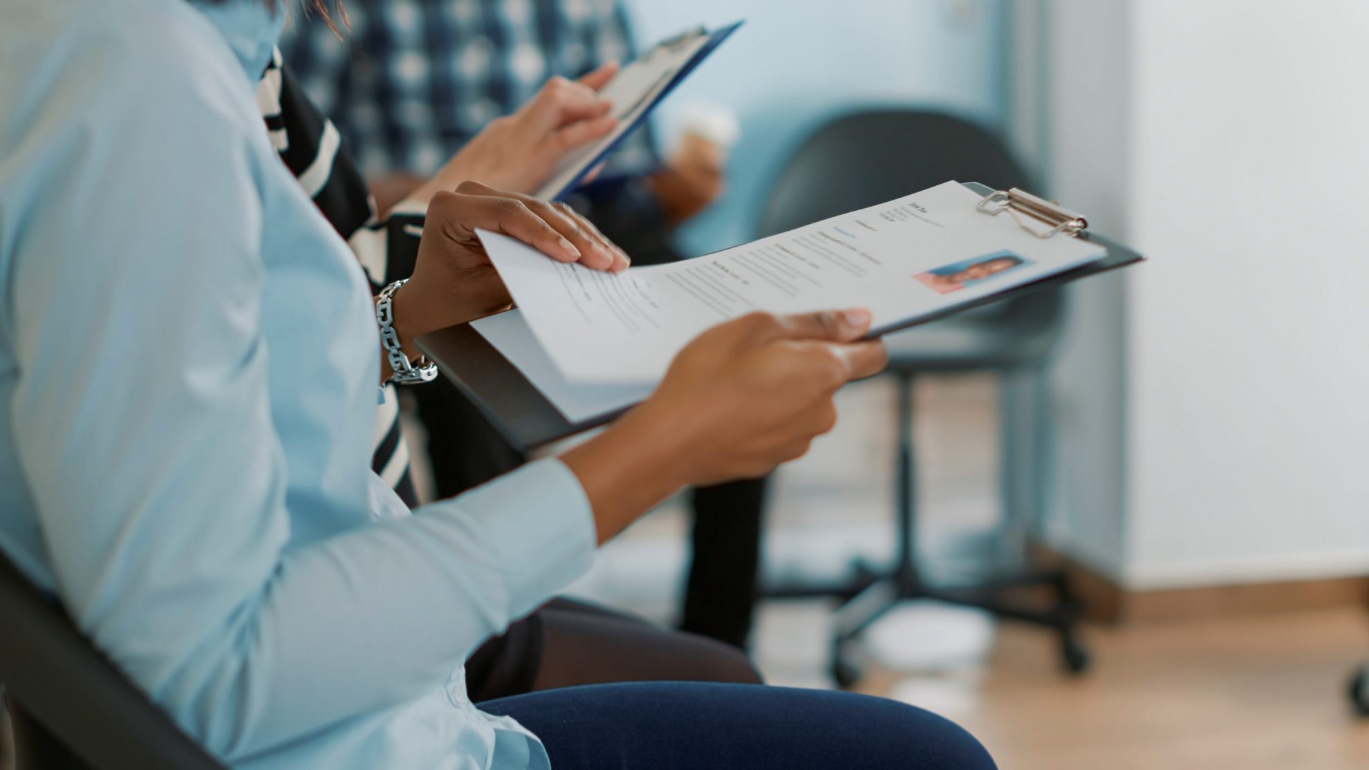 Photo of woman looking at resume illustrates blog: "Will Background Checks Show I Was Fired?"