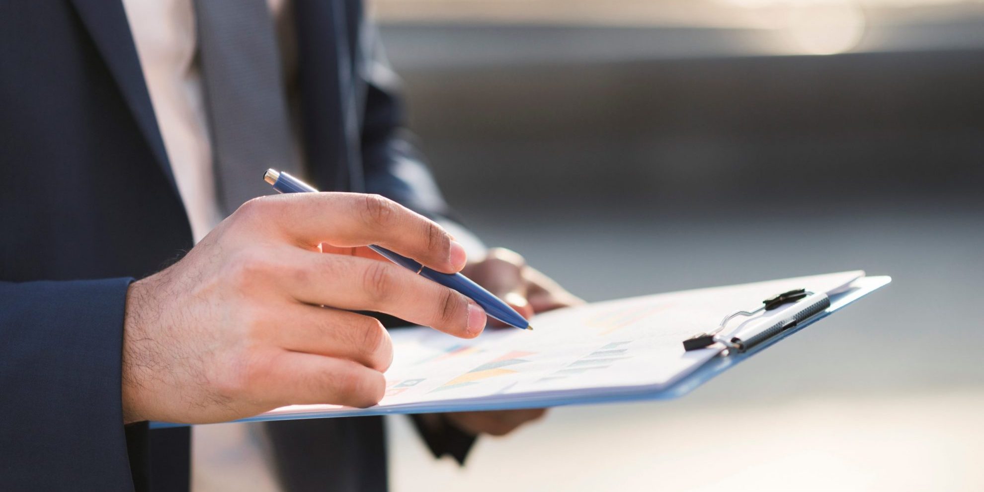 Photo of man holding clipboard illustrates blog: "Are Background Checks Confidential?"