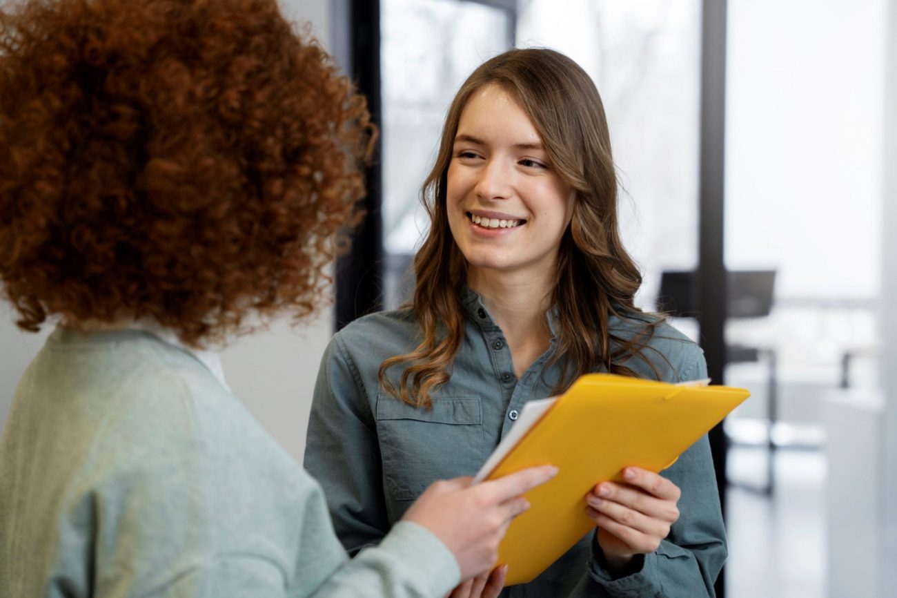 Women holding folder illustrates blog "5 Recruitment Tips for Hiring Managers"