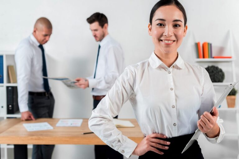 Woman in business attire holding clipboard illustrates blog "Workplace Trends: What is the Big Stay?"