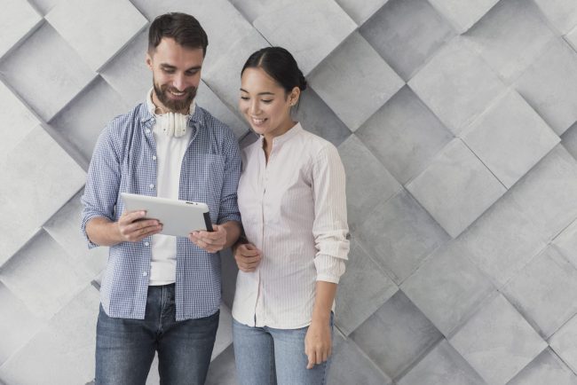 man-woman-casual-fp Man and woman looking at tablet illustrate blog "How to Evaluate a Candidate's Soft Skills"