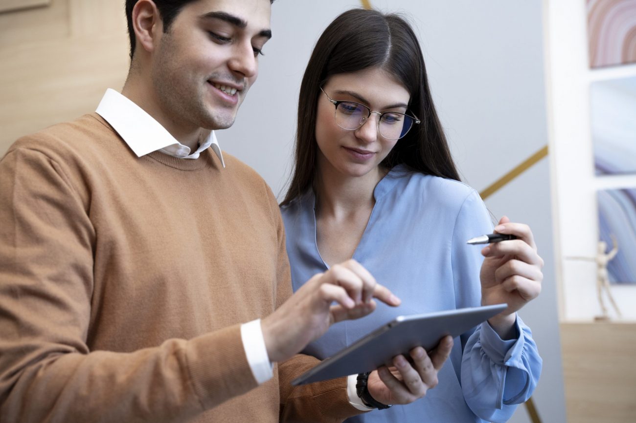 man-woman-office-fp Man and woman looking at tablet in office
