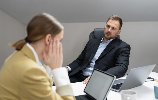 Man and woman in office during job interview.