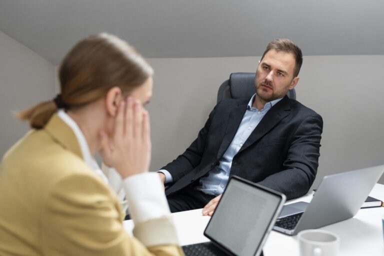 Man and woman in office during job interview.