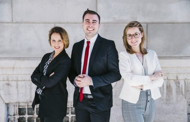 Three smiling office workers.