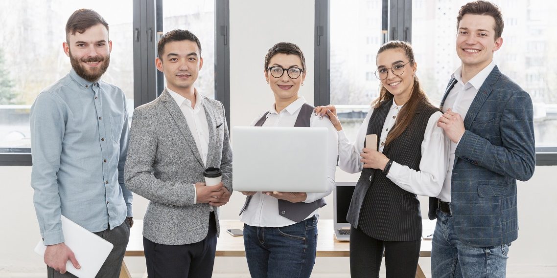 Team in office illustrates blog "Best Practices for Implementing Background Checks in Your Small Business"