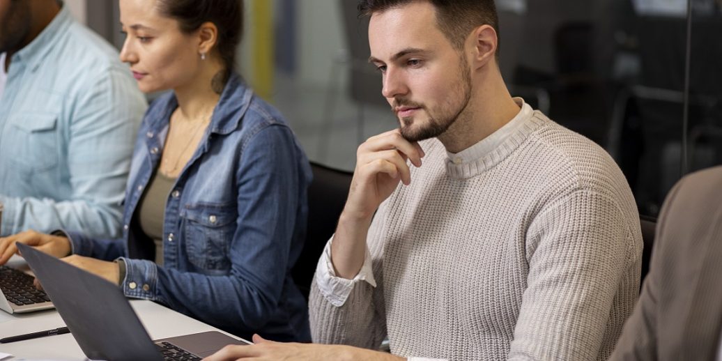 Man looking at computer illustrates blog "Understanding Different Types of Background Checks and Their Applications"
