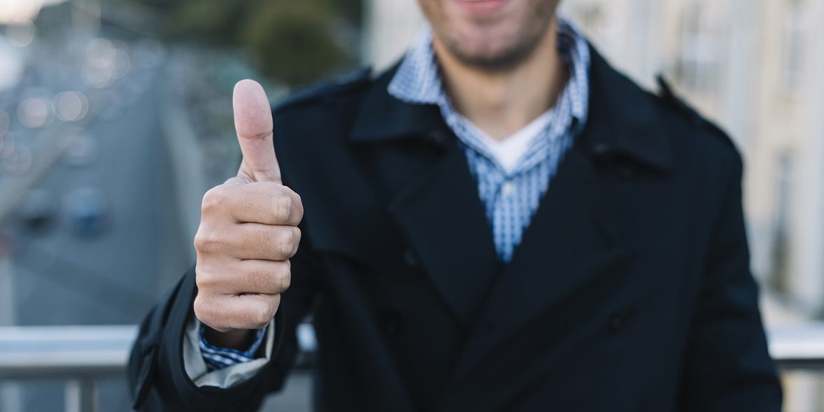 Man giving thumbs up illustrates blog "The Importance of Accurate Employment Verification"