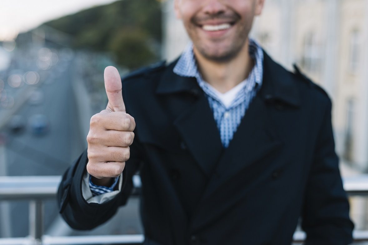 Man giving thumbs up illustrates blog "The Importance of Accurate Employment Verification"